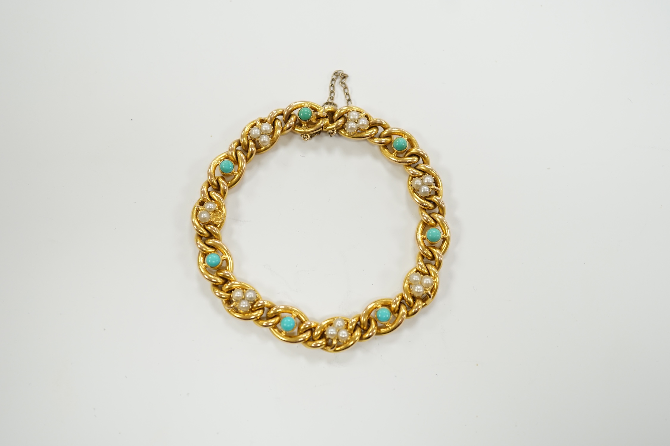 An Edwardian yellow metal (stamped 15), seed pearl cluster and turquoise bead set curb link bracelet, 18cm, gross weight 16.2 grams.